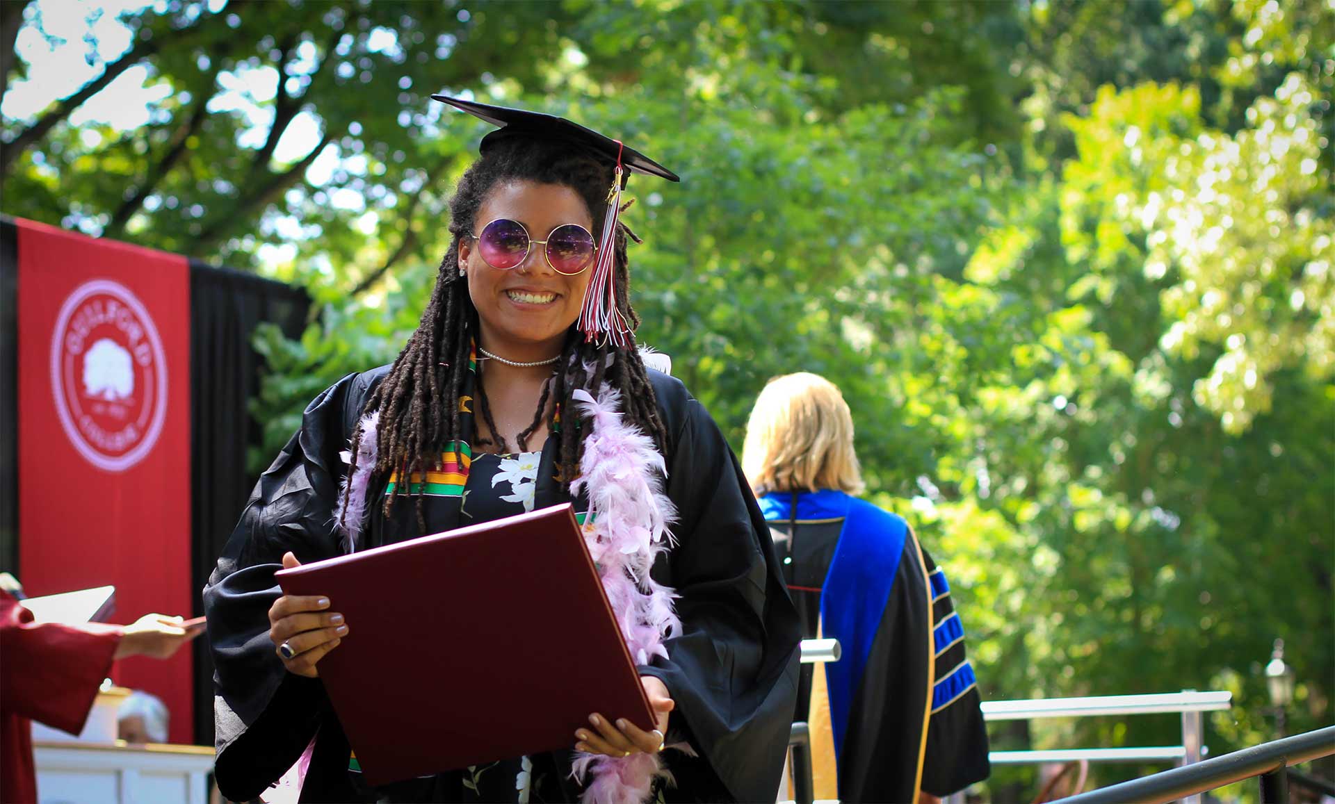 Grads are all smiles as they accept their diplomas.