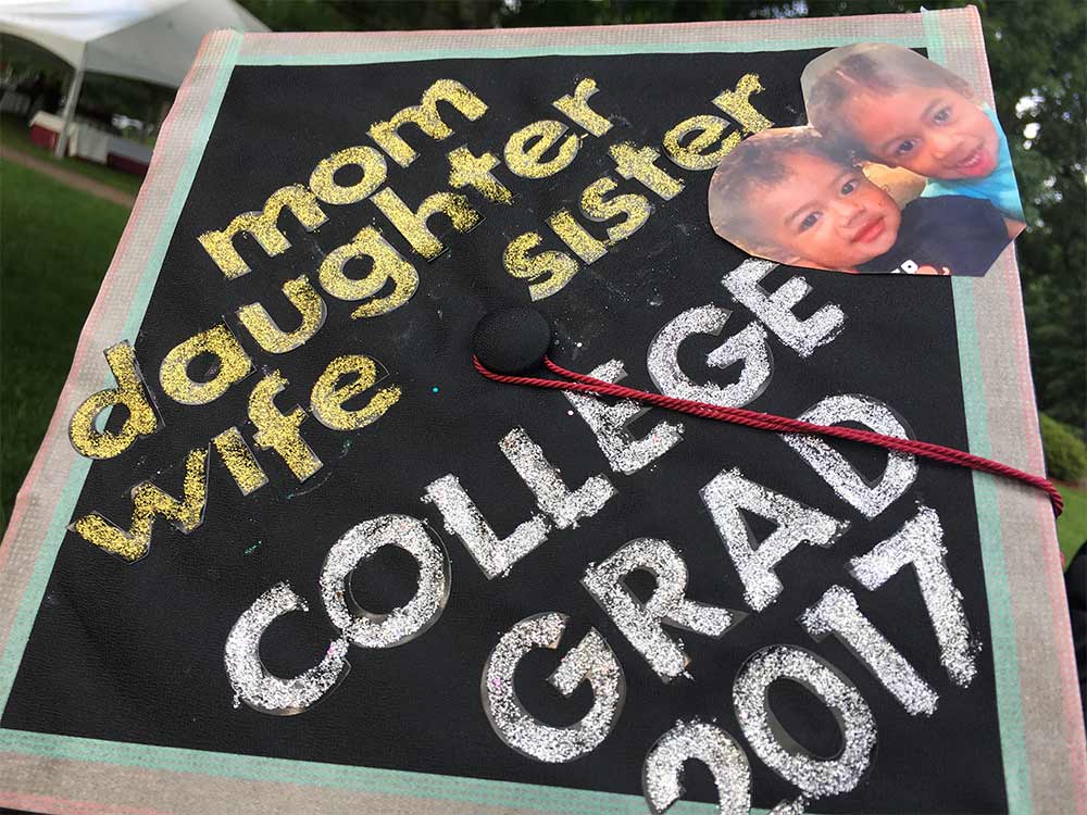 A student's mortarboard announces she's a mom, daughter, wife, sister, and now a college graduate.