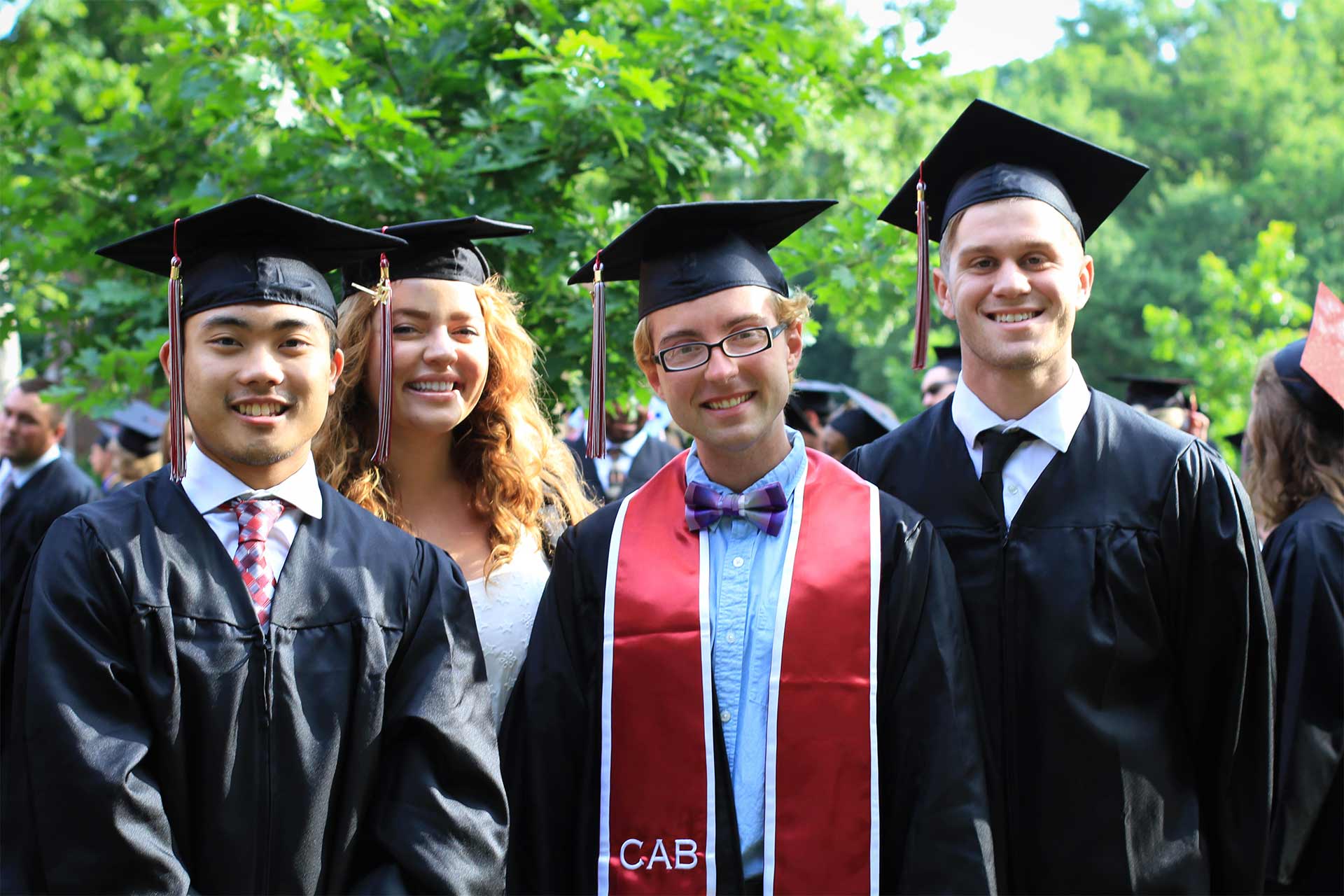 Happy graduates pose for a post-ceremony photo on the Quad.