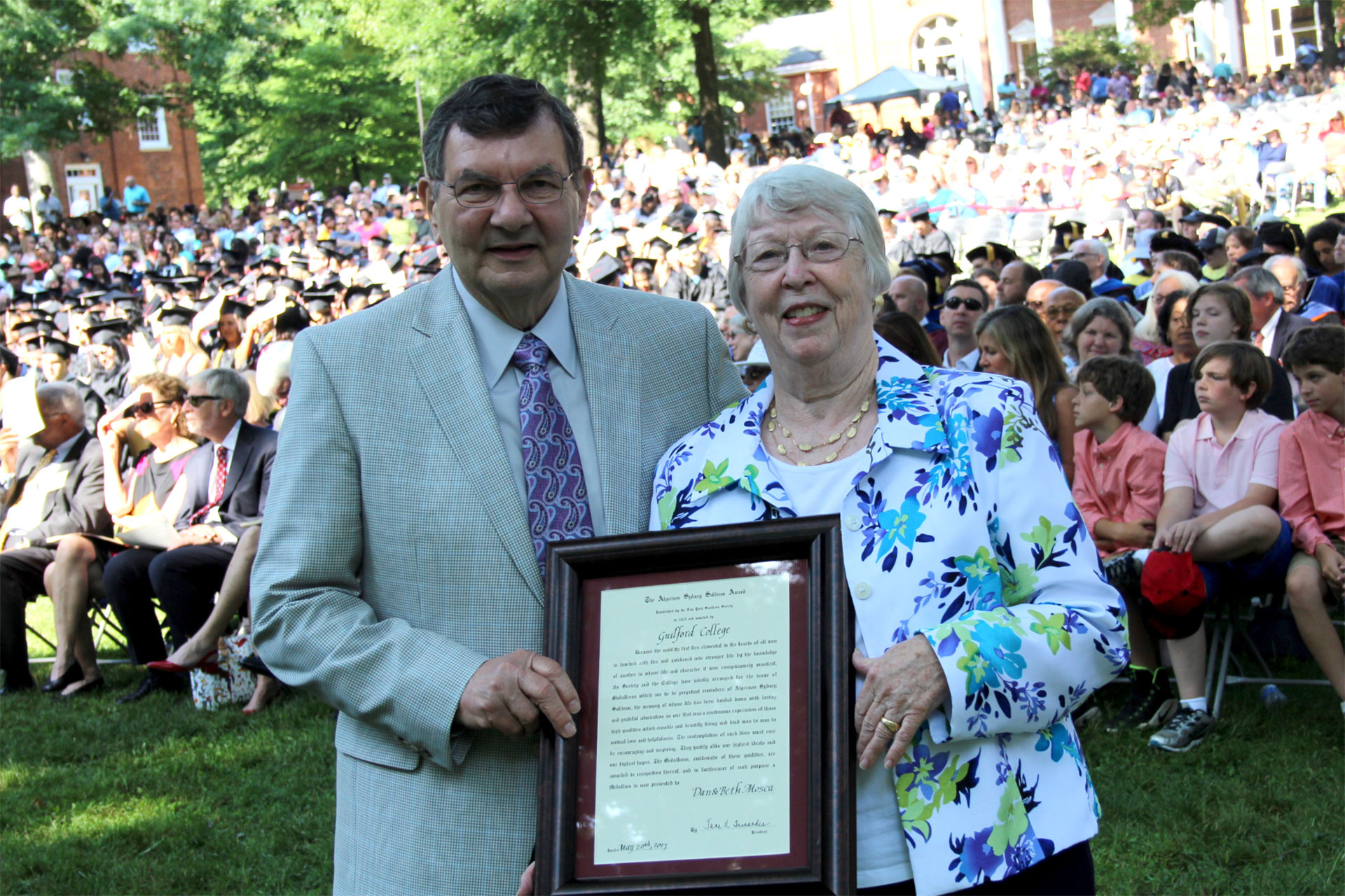 Algernon Sydney Sullivan Award winners Dan and Beth Mosca pose with their framed certificate.