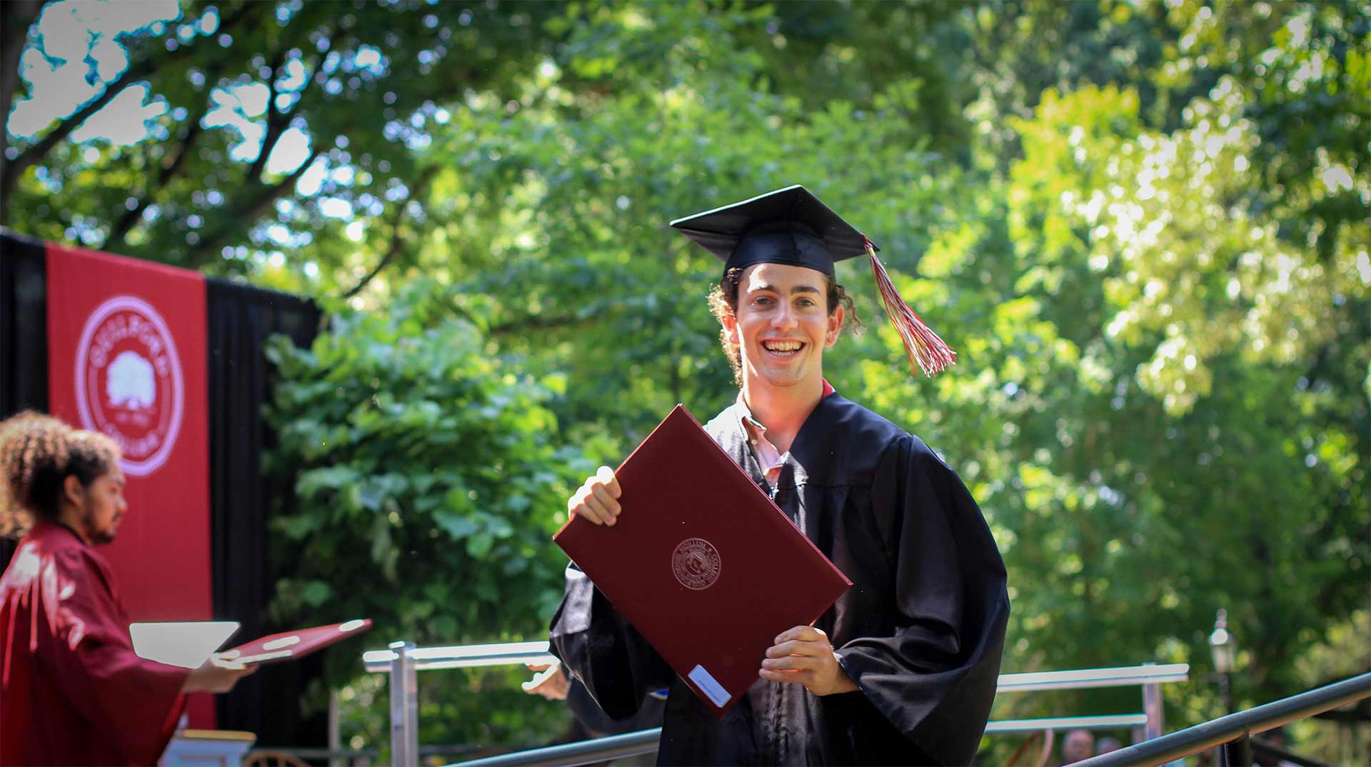 Graduate Patrick Nachlas poses with his diploma.