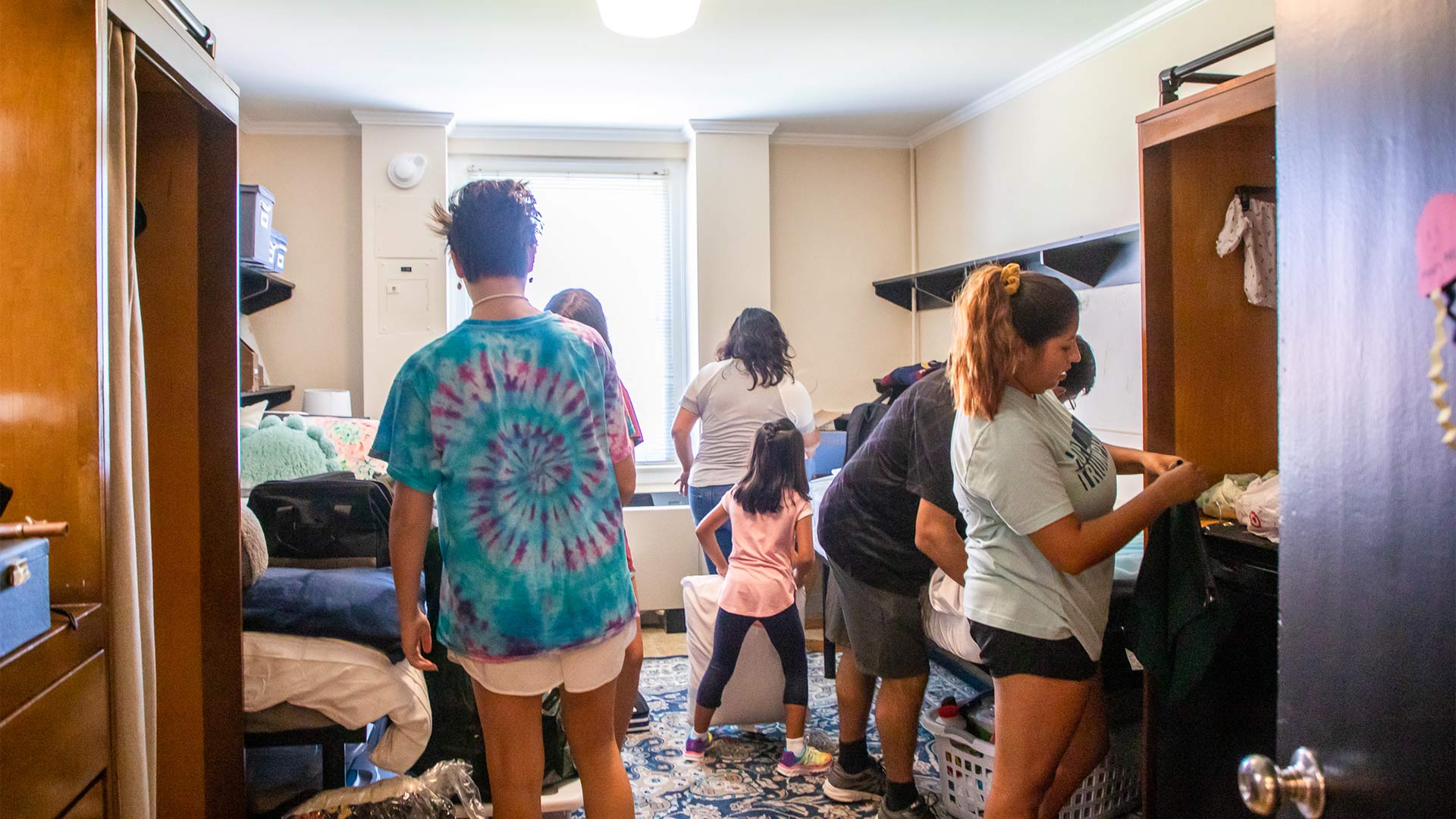 Families help their students set up their new home on move-in day.