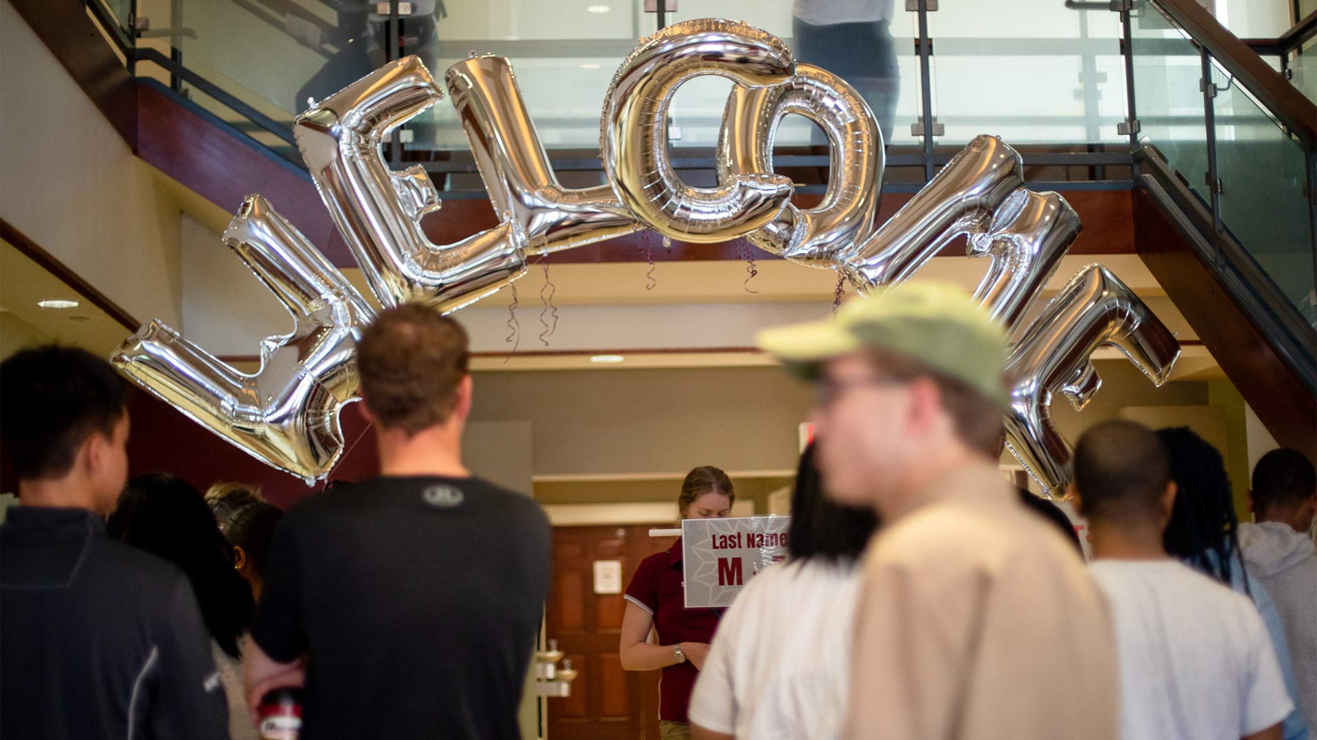 A welcome banner made of balloons welcomes students to Founders Hall on move-in day.