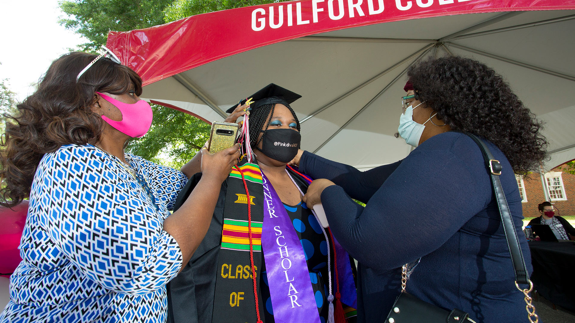 Friends and family prep a graduate for the walk to the auditorium.