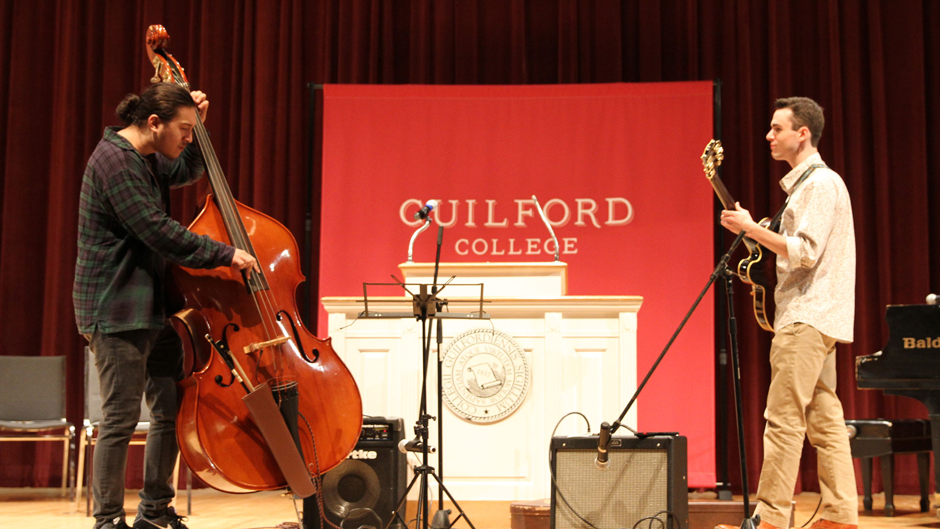 Brandon Walker '22 (left) and Emmett Edwards '23 perform on the upright bass and guitar before Convocation begins.