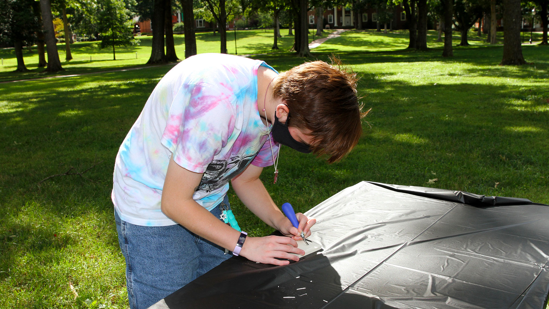 A student makes a decal at Free Press.