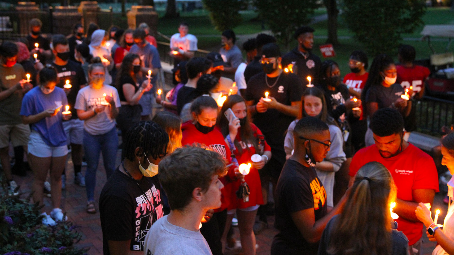 First-year students gather in the dark with their lighted candles at the traditional Passing of the Light ceremony.