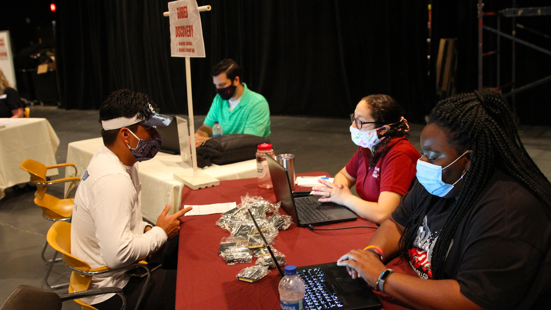 Guilford Guides talk to a student at the Guided Discovery table.