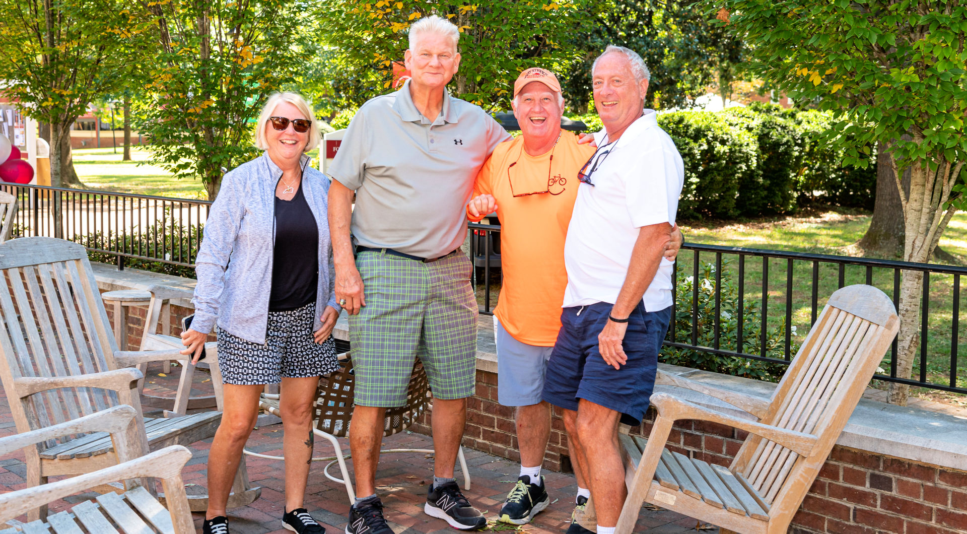 Four Guilfordians take a photo on Founders Hall Patio.