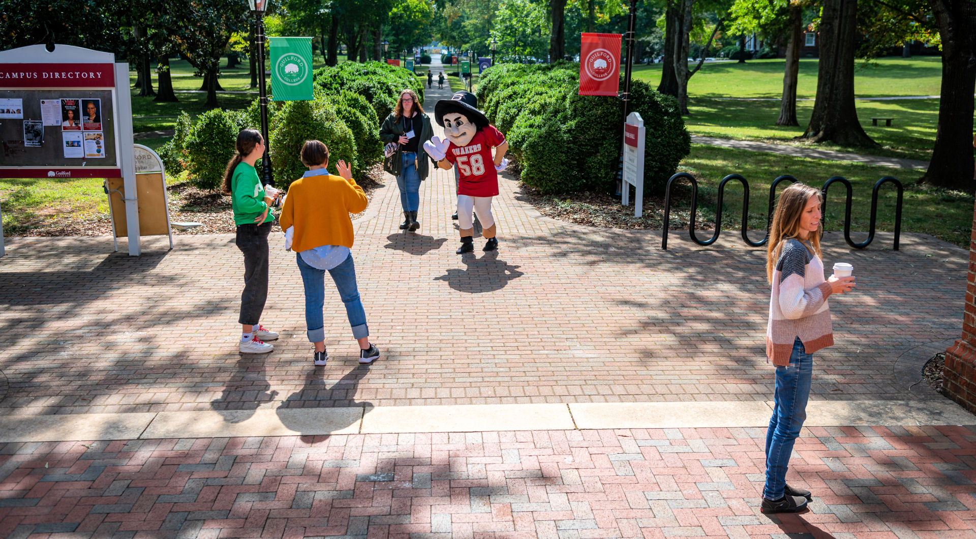 Nathan the Quaker Man mascot greets Guilfordians in front of Founders Hall.