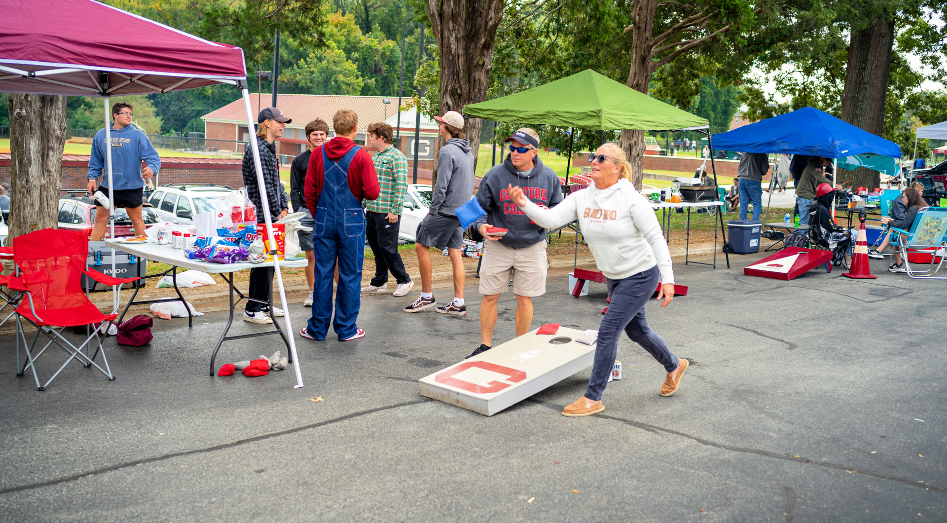 Two Guilfordians play corn hole during tailgating.