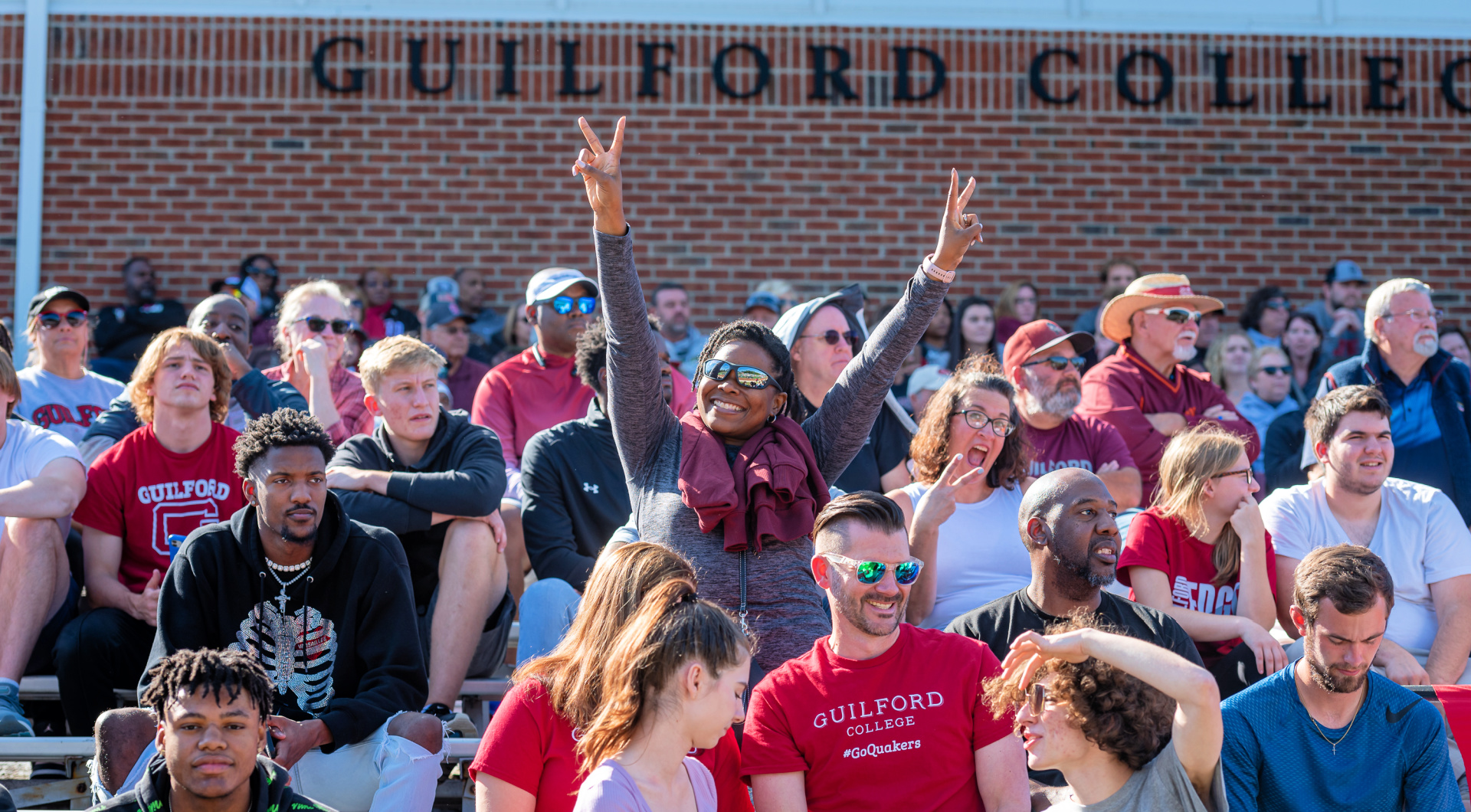 The crowd cheers in the stands at homecoming.