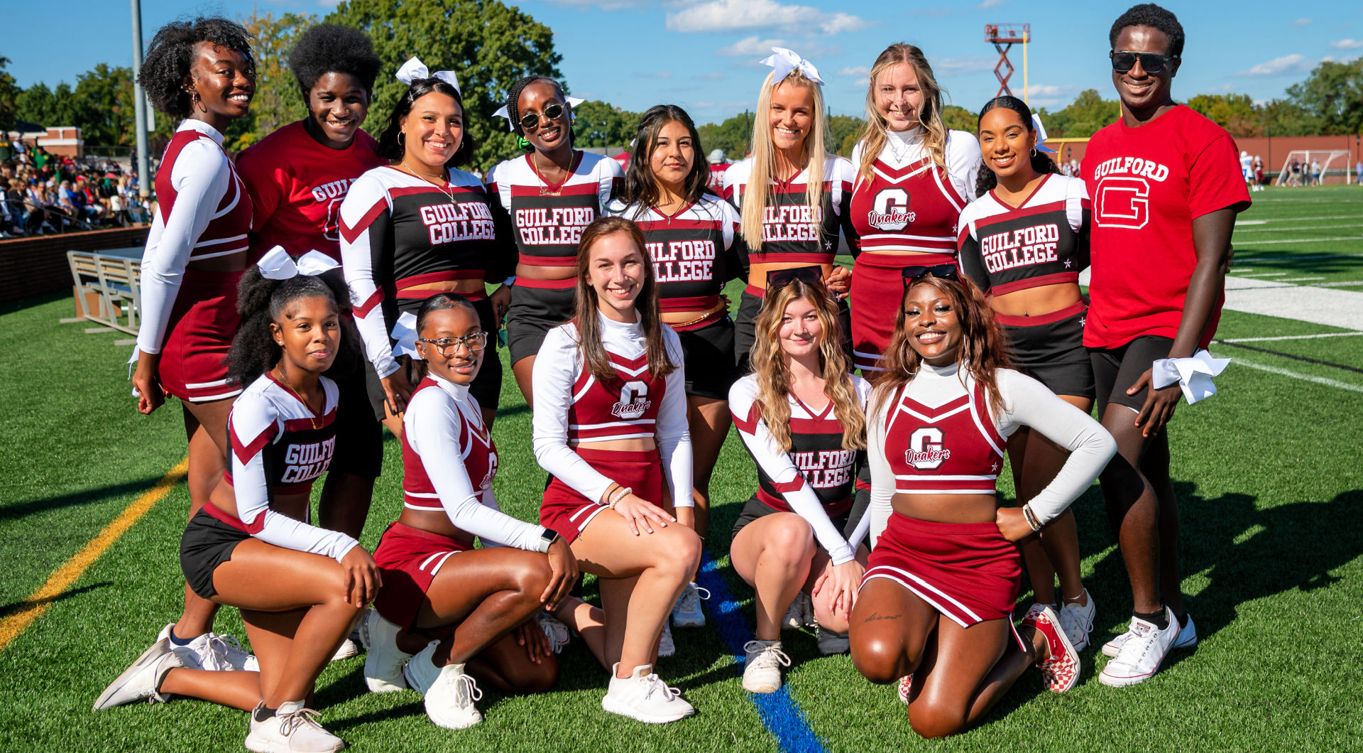 The cheer team takes a group photo at homecoming.