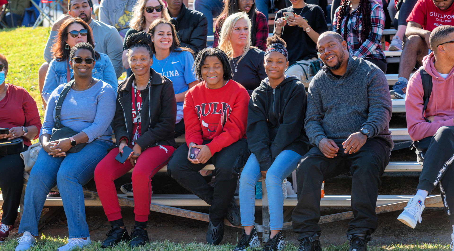 A family of Guilfordians smiles from the stands.