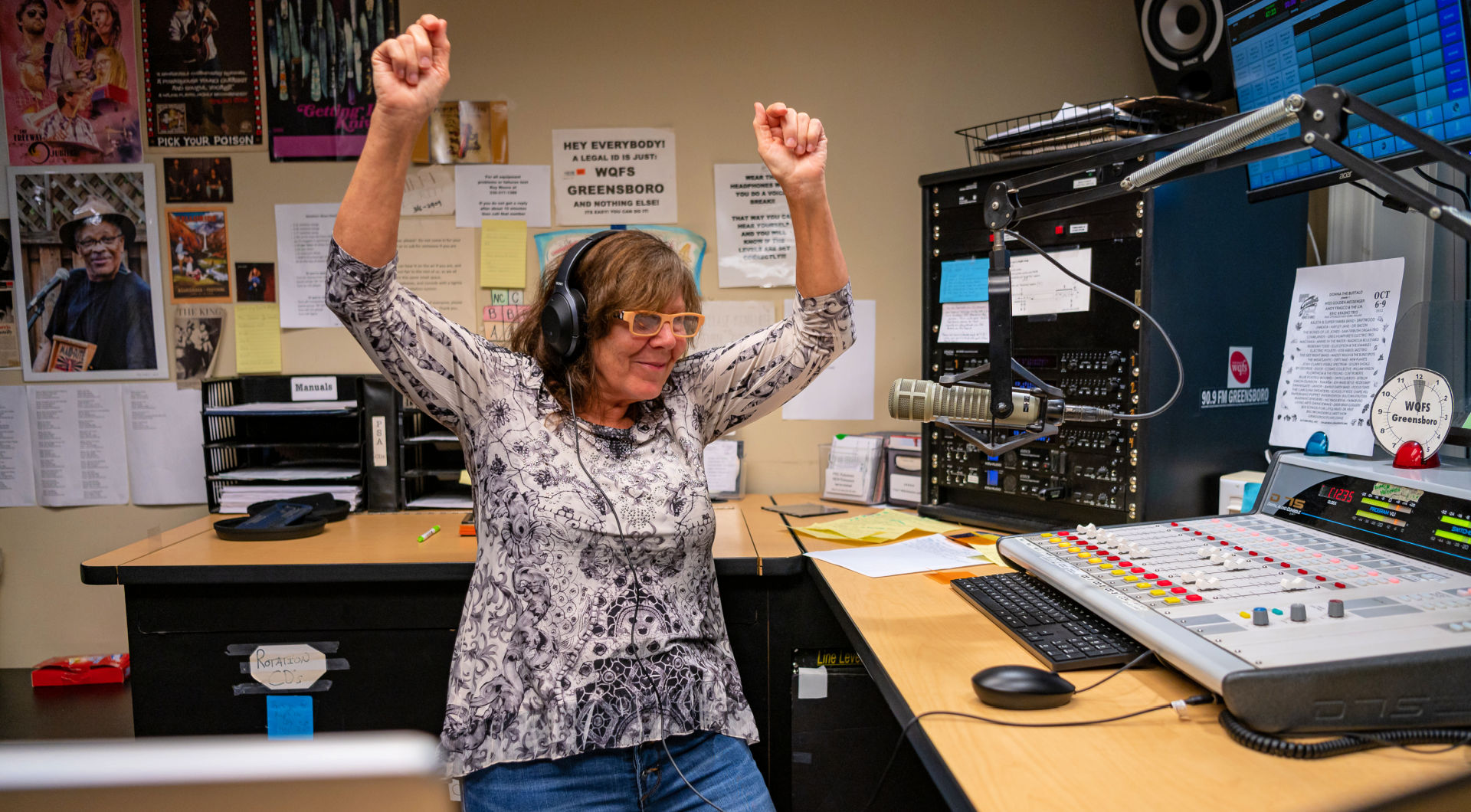 A Guilfordian wearing headphones dances in the WQFS booth.