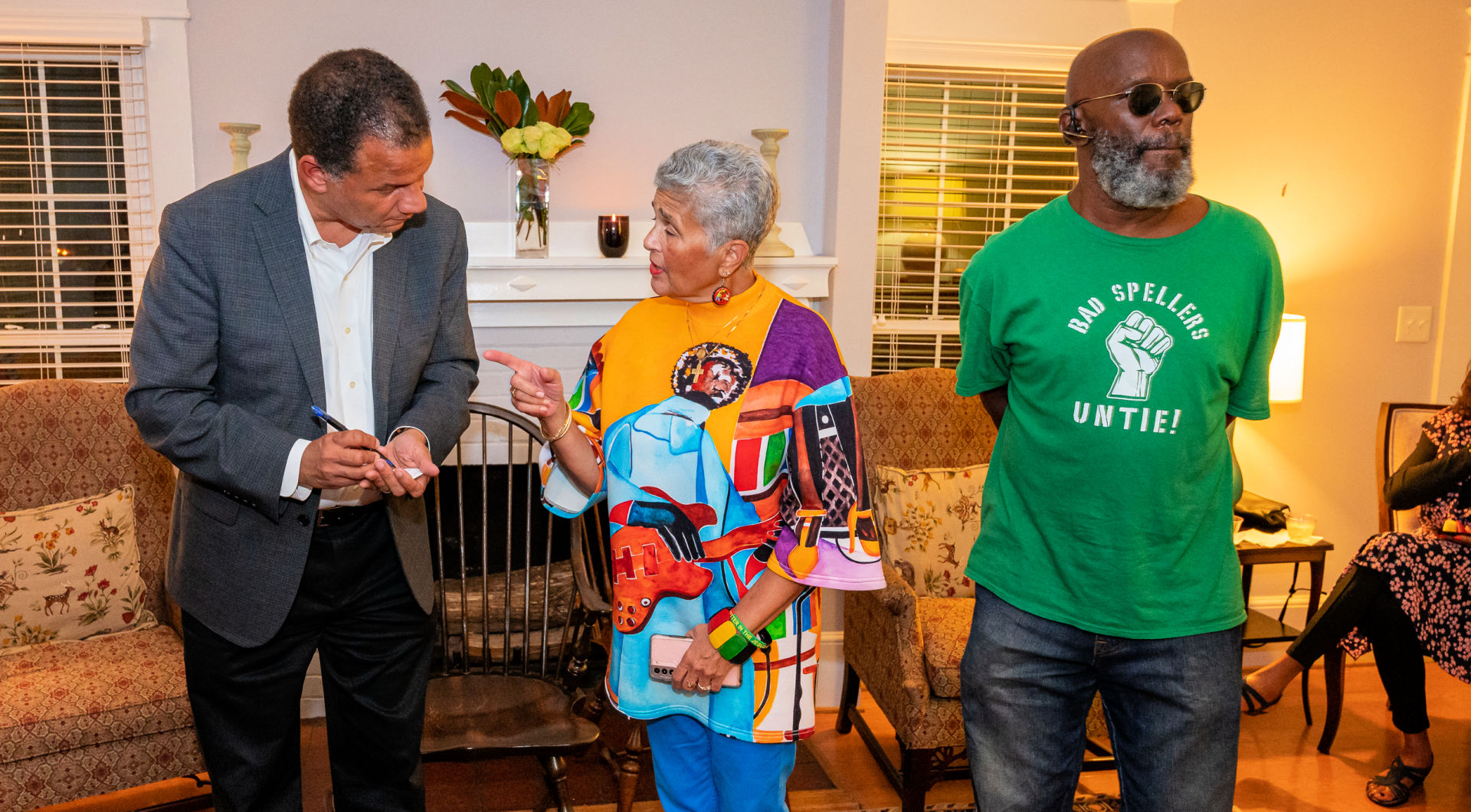 President Kyle Farmbry (left) stands with two Guilfordians in Ragsdale House.