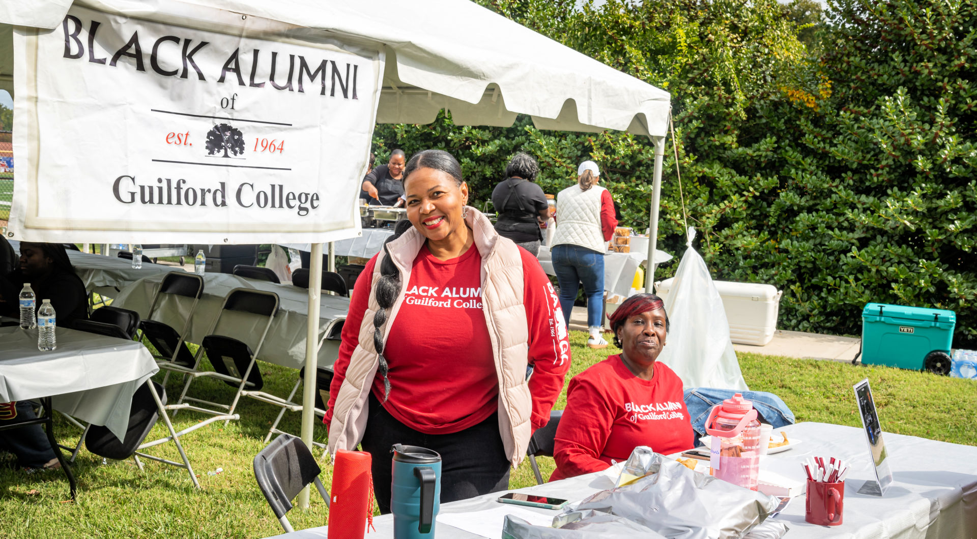 Members of the Black Alumni of Guilford College sit at their booth.