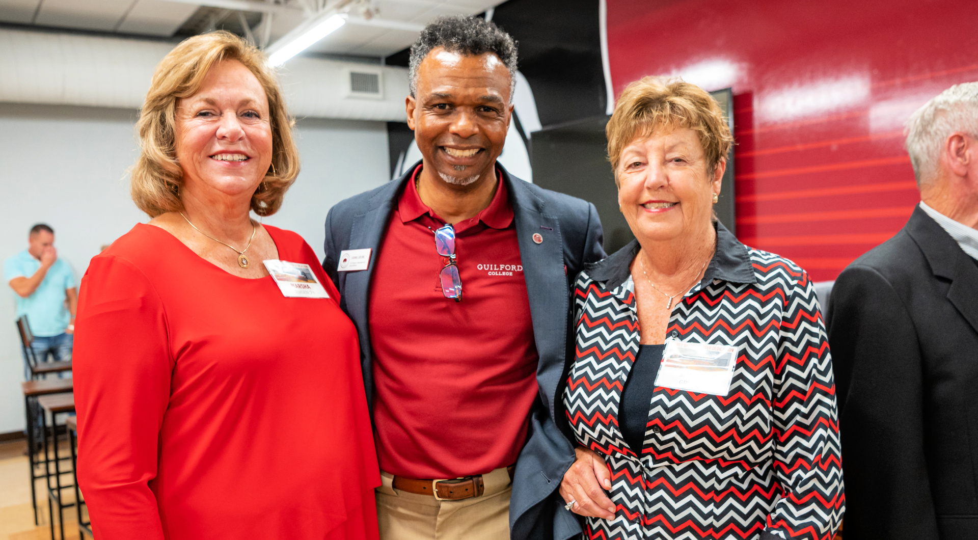 Three Guilfordians smile for a photo in Alumni Hall.