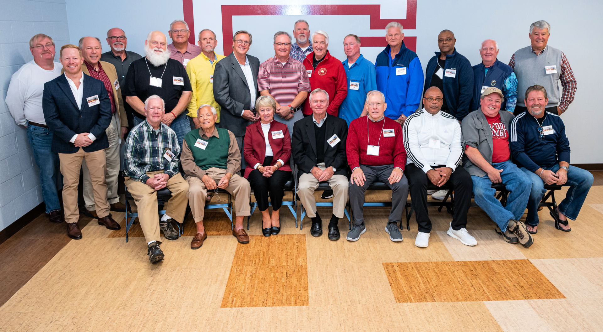 A large group of returning Guilfordians takes a group photo in Alumni Hall.