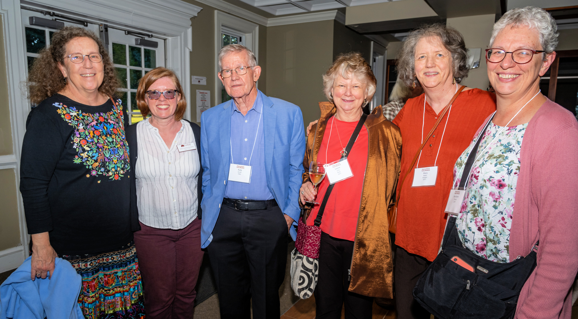 Six Guilfordians take a group photo inside Founders Hall.