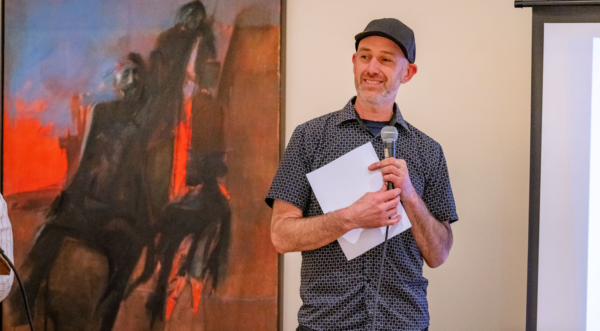 Art Professor Mark Dixon '96 speaks in the Art Gallery.