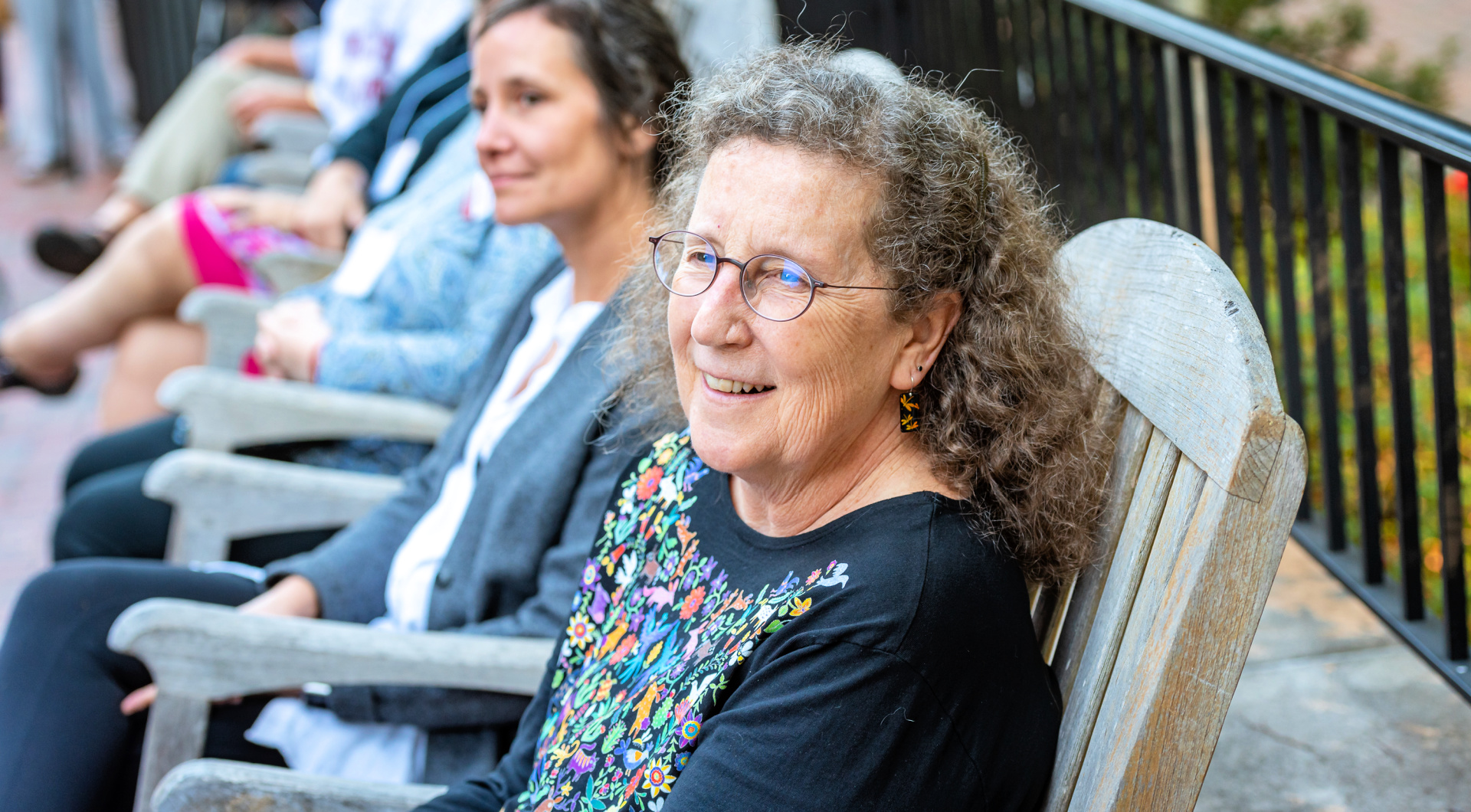 A Guilfordian seated in a rocker attends the Zopf dedication.