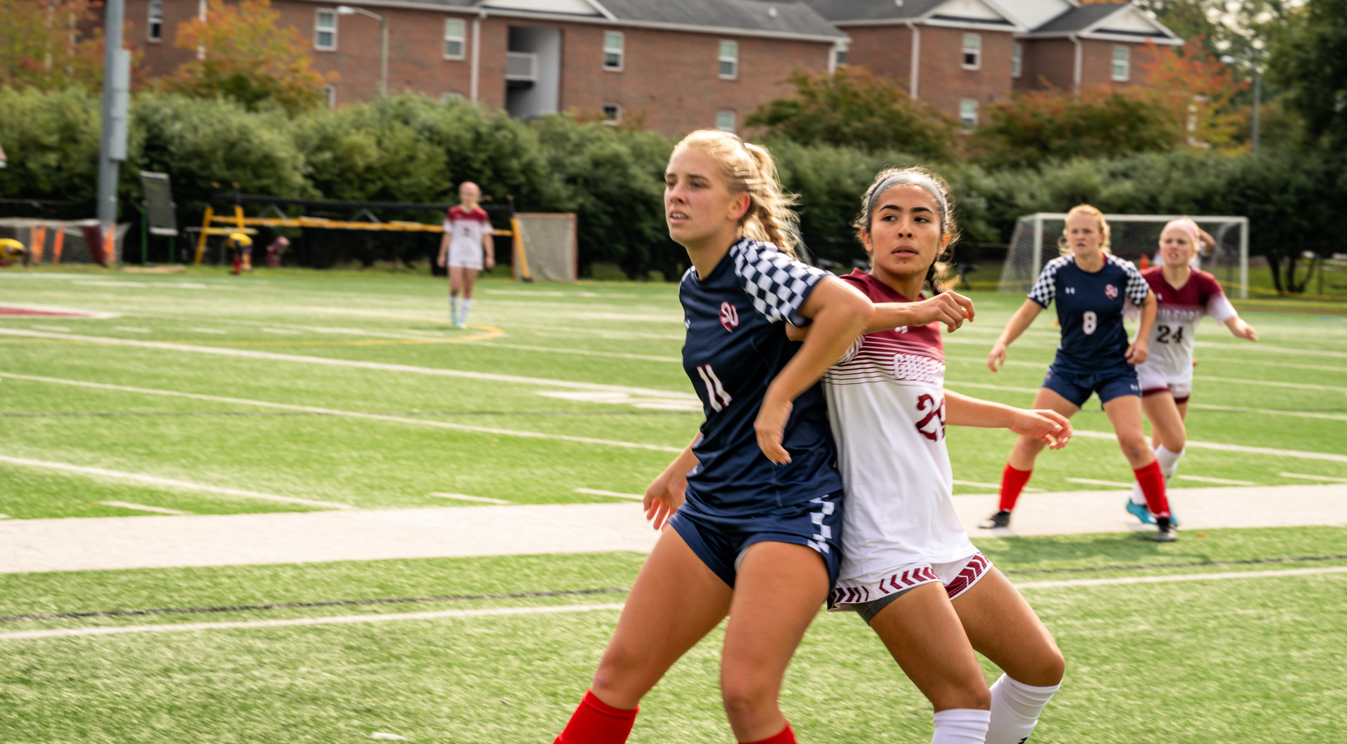 A member of the women's soccer teams battles for the ball.