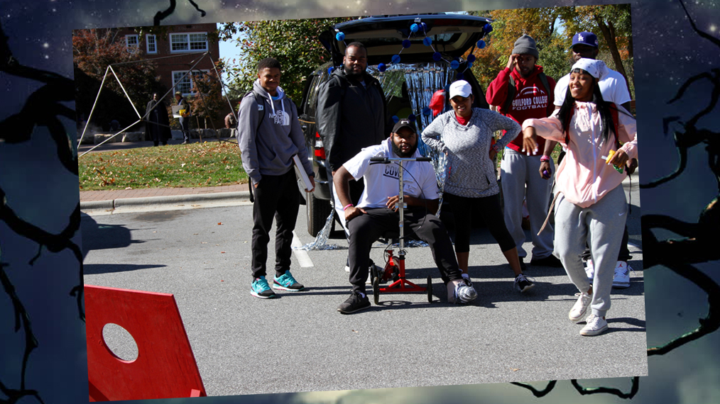 Students play corn hole at a Halloween festival.