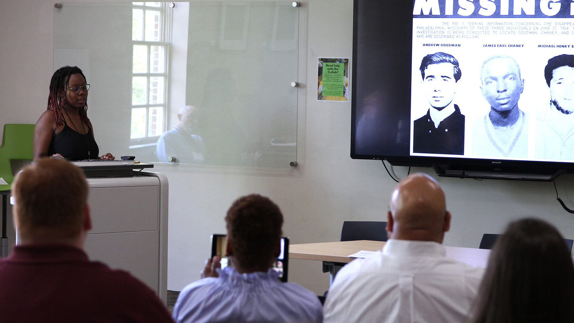 A student gives a digital presentation at GUS.