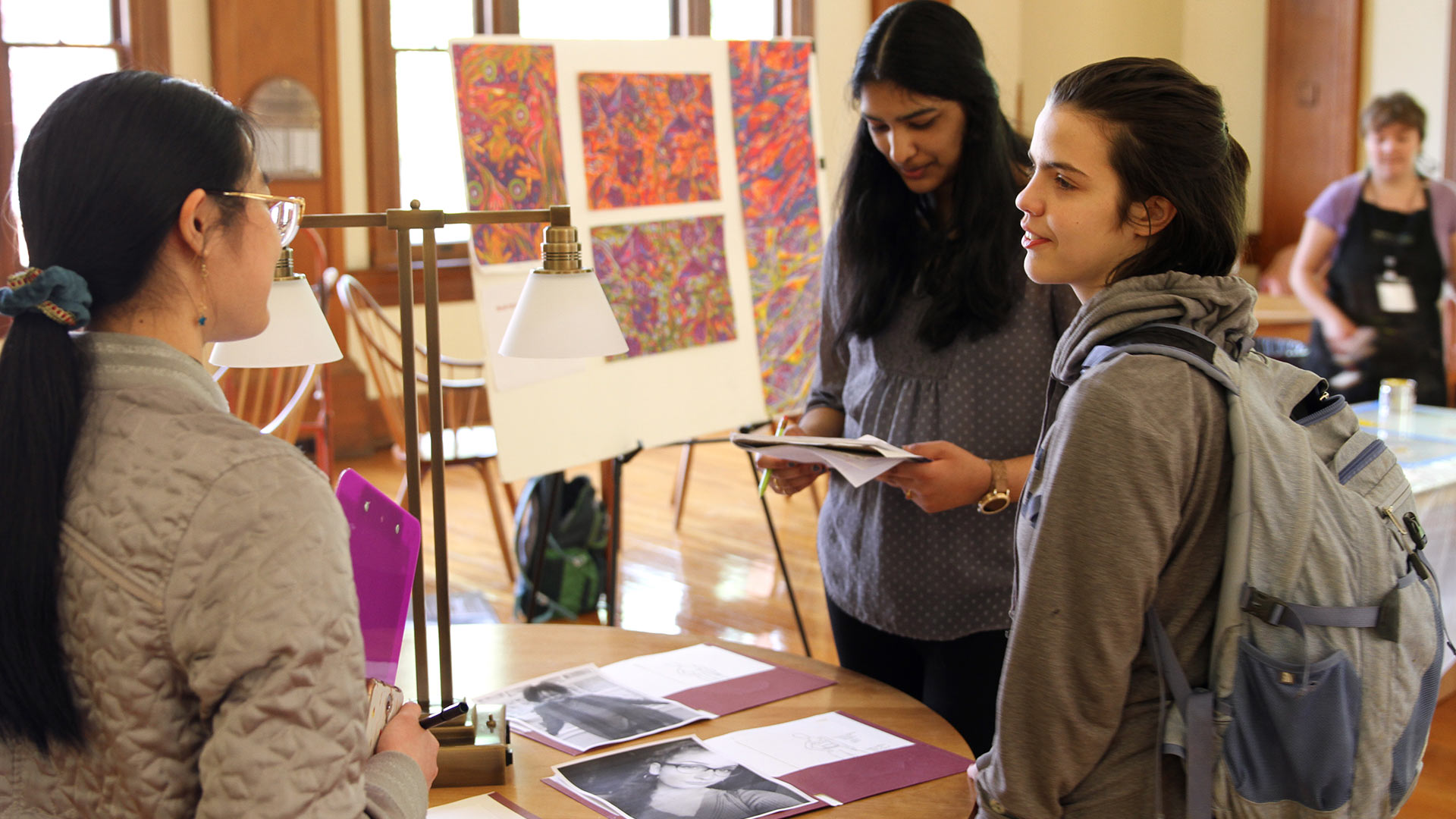 Students hold conversations about their research at GUS.