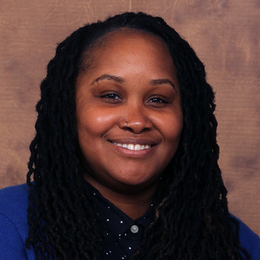 Lakeshia Williams in a blue shirt against a brown background